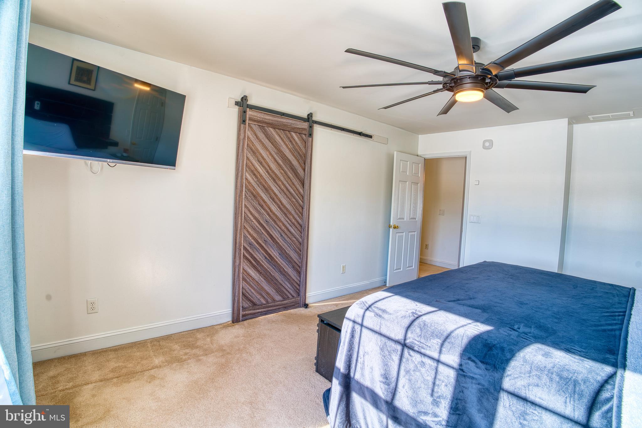 2412 Midstate Road Felton, DE 19943 - Photo 49 of 93 a bedroom with a bed and a flat screen tv
