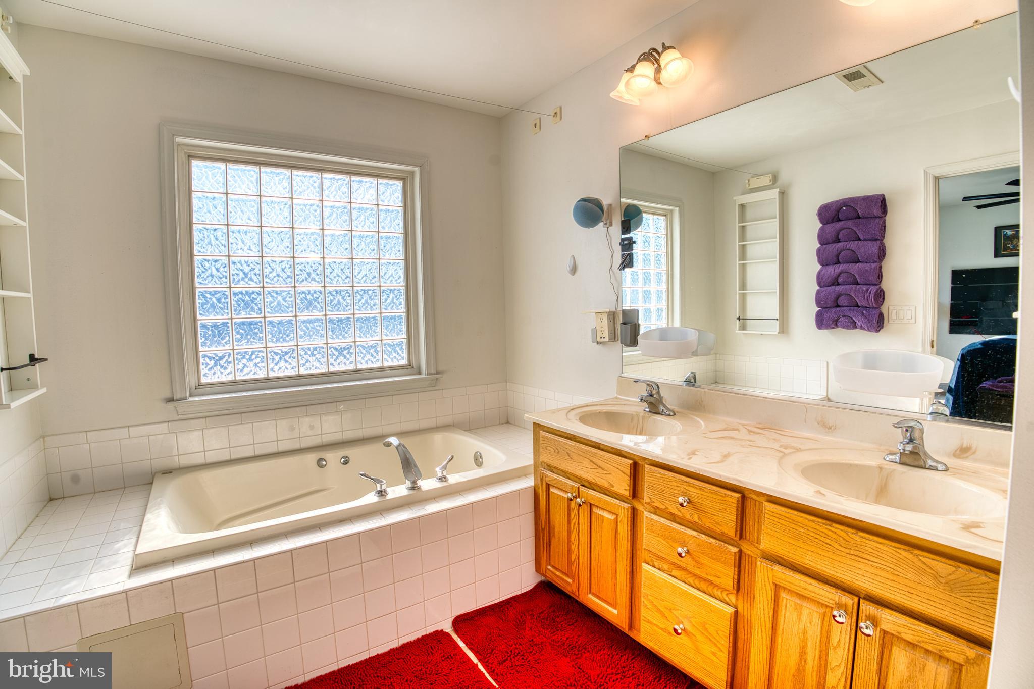 2412 Midstate Road Felton, DE 19943 - Photo 53 of 93 a bathroom with a granite countertop tub sink and mirror