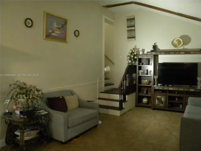 a dining room with furniture and a floor to ceiling window