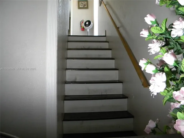 a bedroom with a bed and dresser with mirror