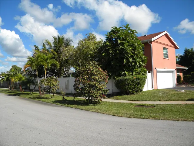 a garden with trees in front of it