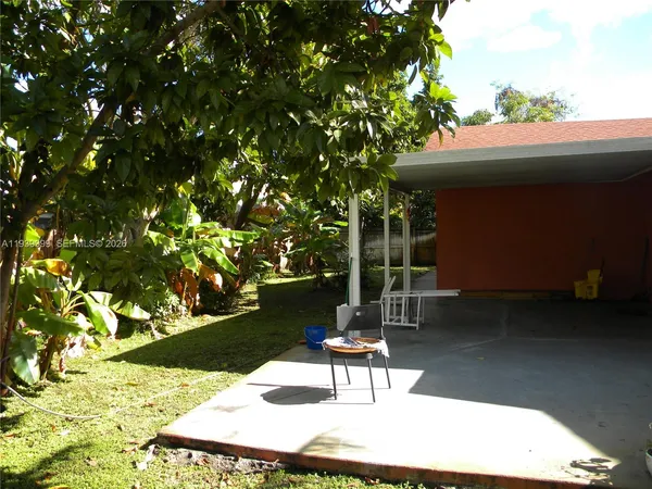 a garden with trees in front of it