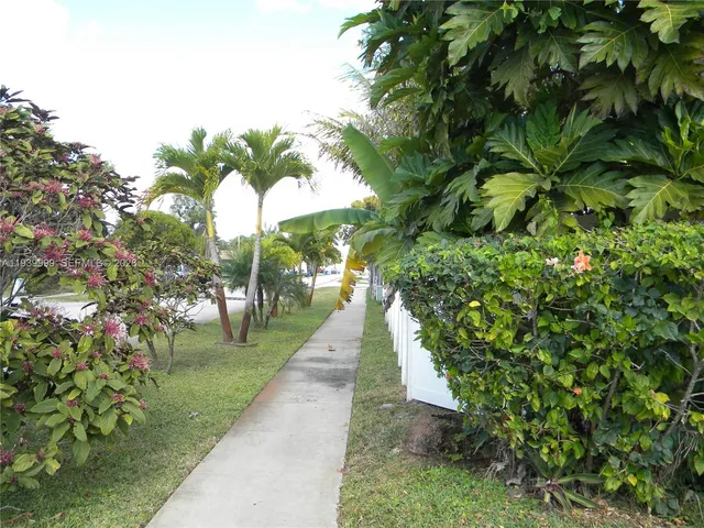 a kitchen with stainless steel appliances granite countertop a refrigerator a stove and a sink