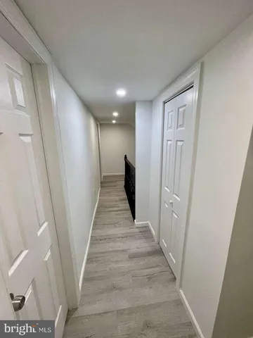 a view of a hallway with wooden floor and entryway