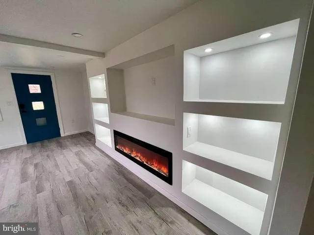 a view of an empty room and fire place