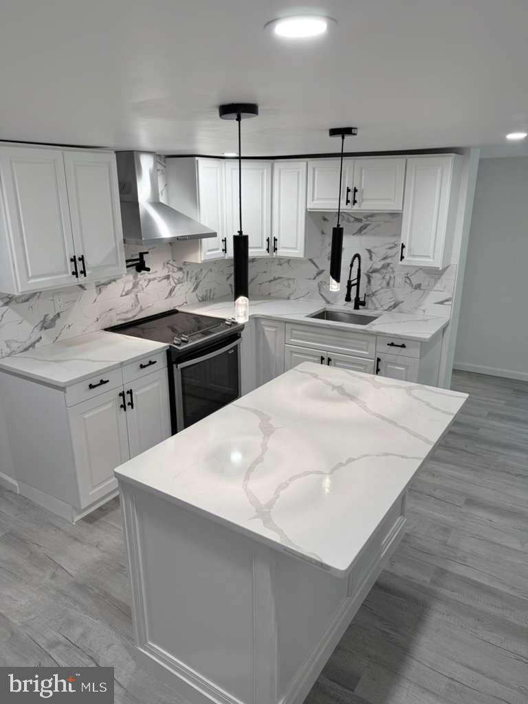 131 Schaeffer Hill Road Pottsville, PA 17901 - Photo 7 of 18 a kitchen with a sink a stove a refrigerator and white cabinets