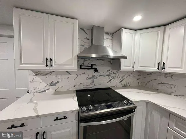 a kitchen with a sink stove and cabinets