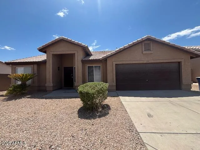 a front view of a house with a yard and garage