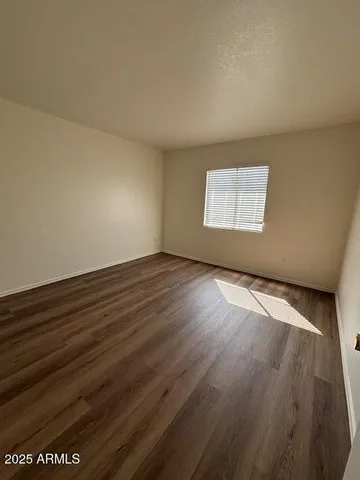 a bathroom with a granite countertop sink a toilet a mirror and bathtub
