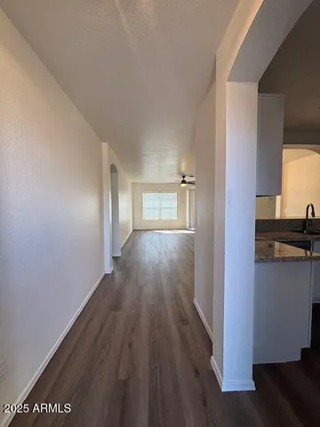 a kitchen with kitchen island granite countertop white cabinets and refrigerator
