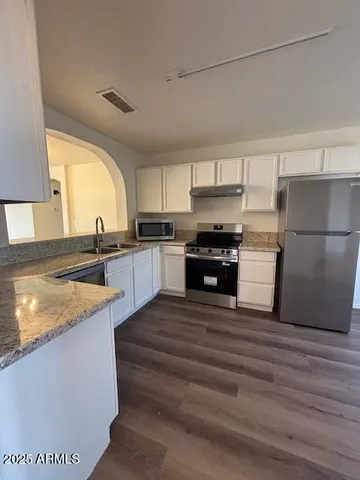 a view of a room with wooden floor