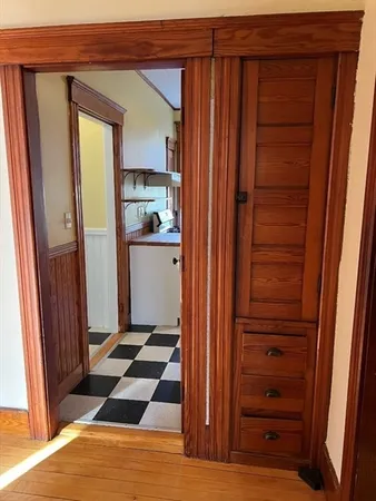a room with a walk in closet and wooden floor