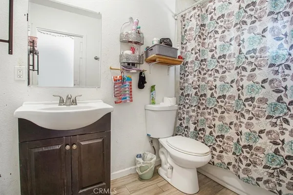 a bathroom with a sink toilet and mirror