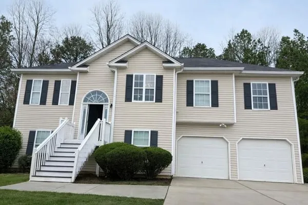 a front view of a house with a yard and garage