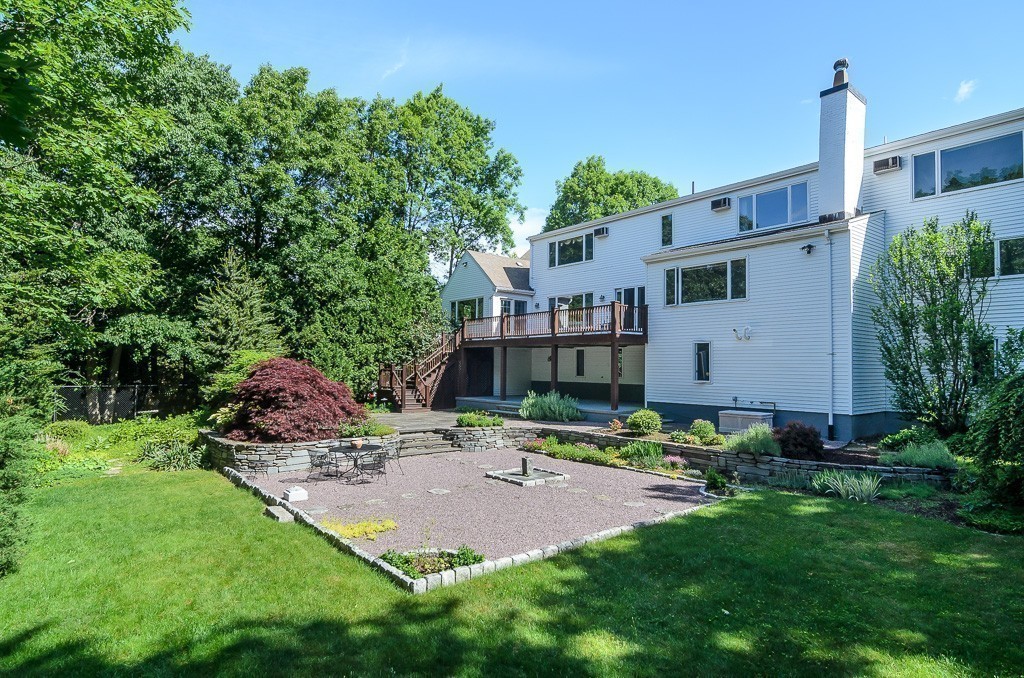 22 Cranmore Road Wellesley, MA 02481 - Photo 2 of 22 a backyard of a house with table and chairs