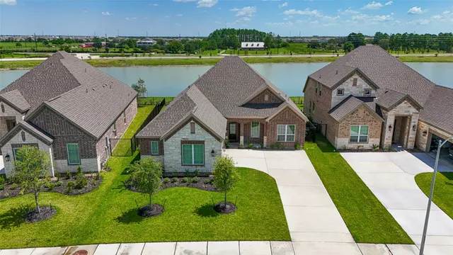 a aerial view of a house with a big yard and large tree