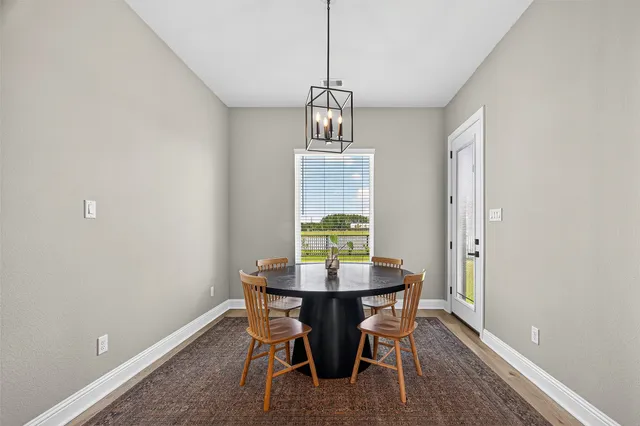 a view of a dining room with a table and chairs