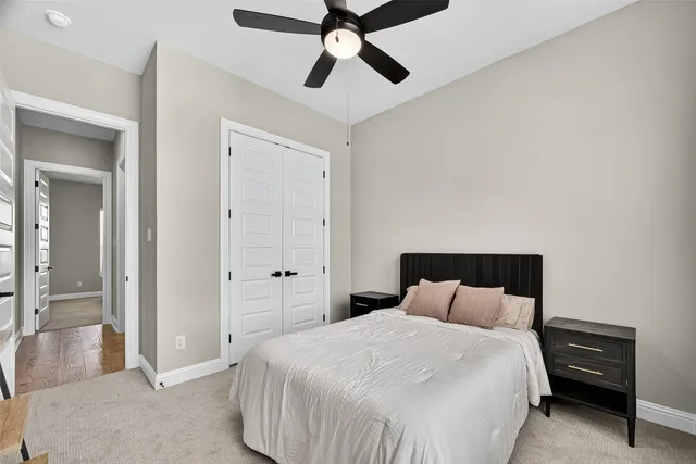 a bedroom with a bed and a chandelier