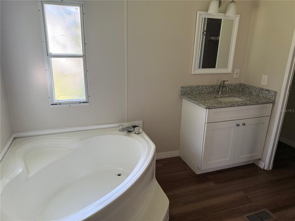 4113 Shady View Run Mulberry, FL 33860 - Photo 12 of 17 a bathroom with a granite countertop sink and a bathtub