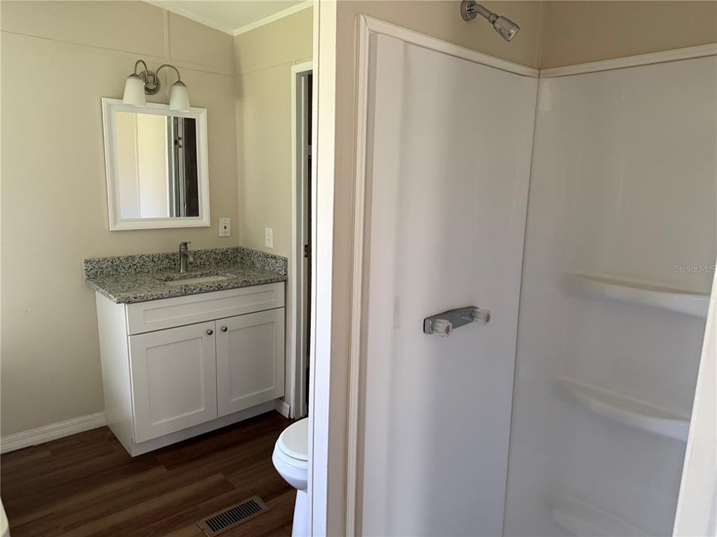 4113 Shady View Run Mulberry, FL 33860 - Photo 13 of 17 a bathroom with a granite countertop sink toilet and shower