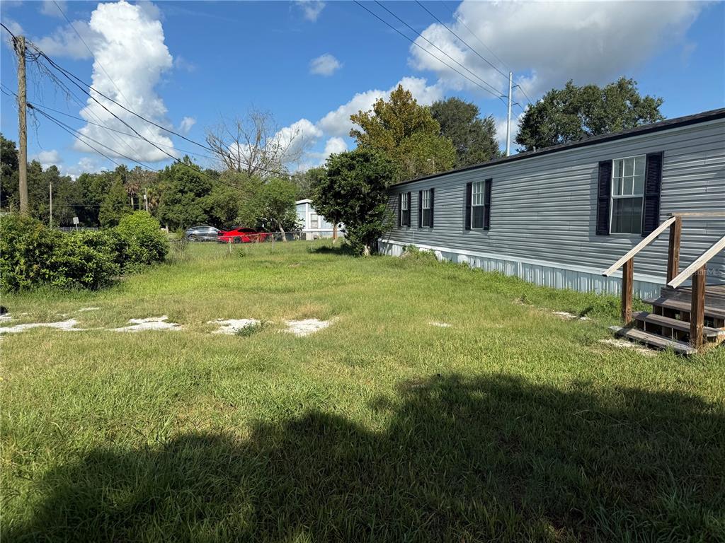 4113 Shady View Run Mulberry, FL 33860 - Photo 17 of 17 a view of a house with a backyard and sitting area