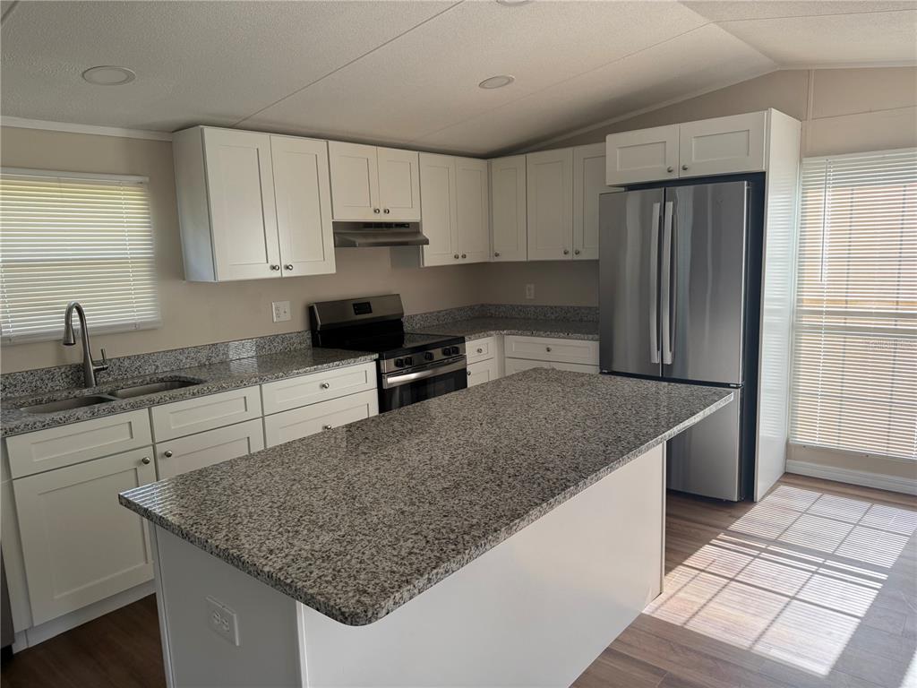 4113 Shady View Run Mulberry, FL 33860 - Photo 3 of 17 a kitchen with stainless steel appliances granite countertop a sink stove and refrigerator