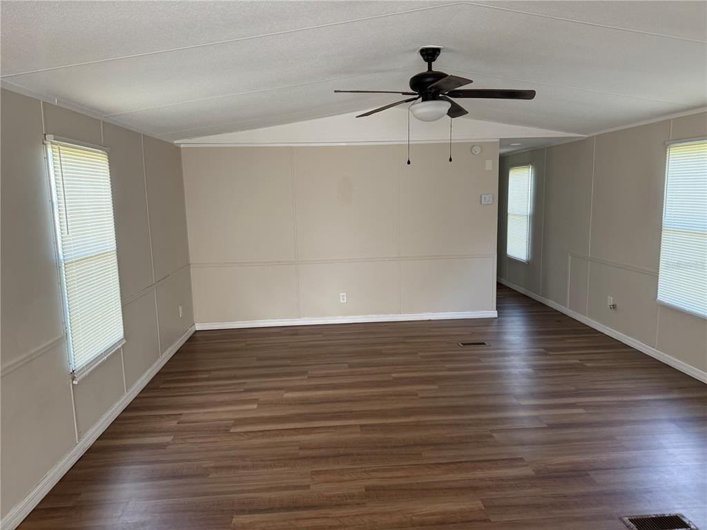 4113 Shady View Run Mulberry, FL 33860 - Photo 8 of 17 a view of empty room with wooden floor and fan