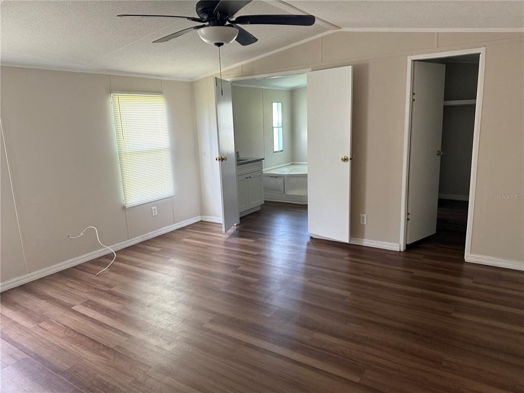 4113 Shady View Run Mulberry, FL 33860 - Photo 10 of 17 an empty room with wooden floor and a window