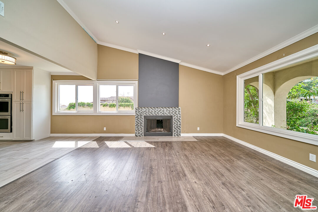 2660 Conata Street Duarte, CA 91010 - Photo 16 of 64 an empty room with wooden floor a fireplace and windows