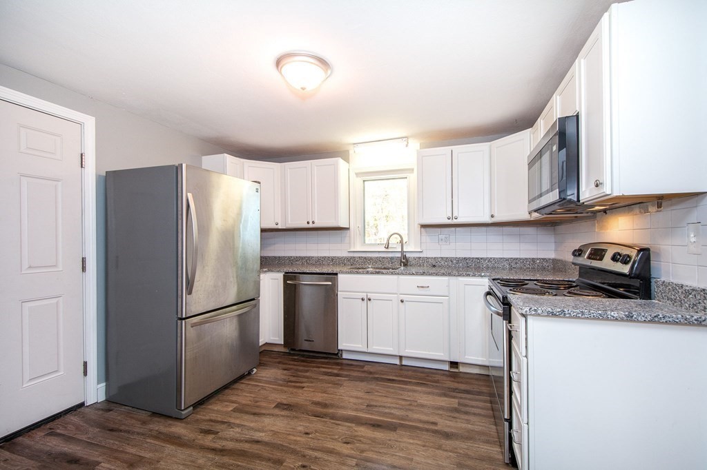 226 Beaver Dam Road Scituate, MA 02066 - Photo 2 of 12 a kitchen with granite countertop a refrigerator stove top oven and sink