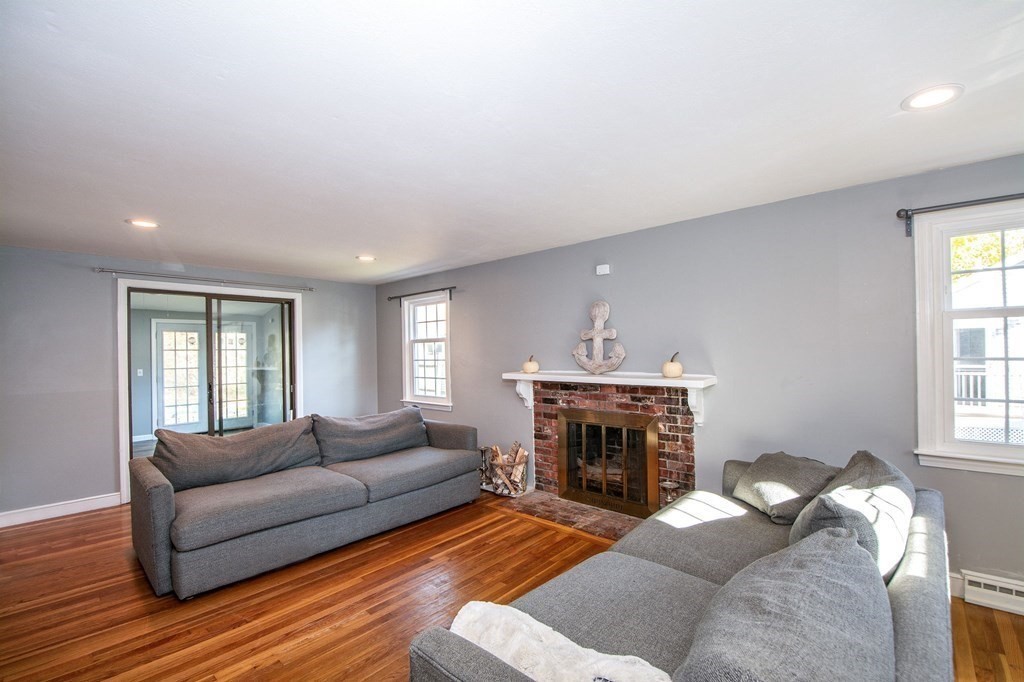 226 Beaver Dam Road Scituate, MA 02066 - Photo 5 of 12 a living room with furniture a window and a fireplace