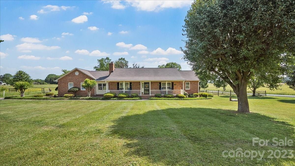 425 Baucom Road Monroe, NC 28110 - Photo 16 of 48 a front view of a house with a garden