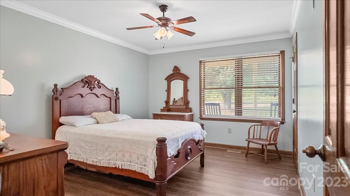 425 Baucom Road Monroe, NC 28110 - Photo 30 of 48 a bedroom with a bed and a chandelier