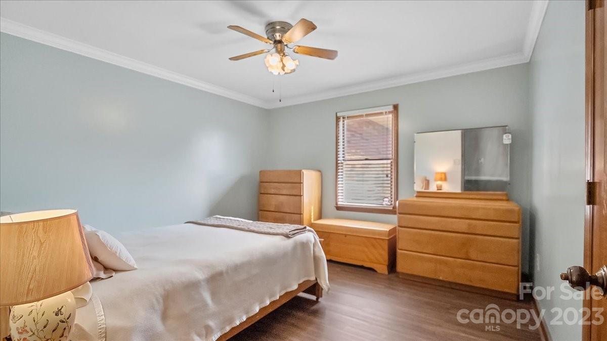 425 Baucom Road Monroe, NC 28110 - Photo 31 of 48 a bedroom with a bed and a chandelier