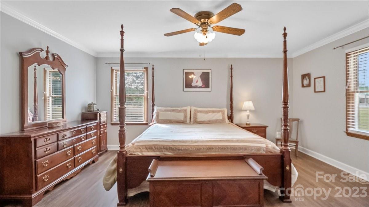 425 Baucom Road Monroe, NC 28110 - Photo 32 of 48 a bedroom with a bed and a chandelier