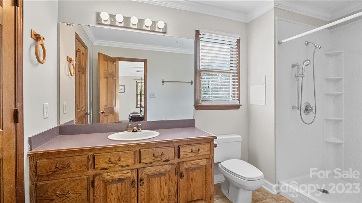 425 Baucom Road Monroe, NC 28110 - Photo 34 of 48 a bathroom with a sink toilet a mirror and shower