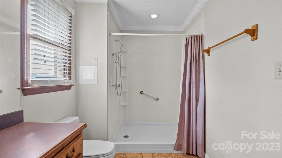 425 Baucom Road Monroe, NC 28110 - Photo 35 of 48 a bathroom with a shower a toilet and a window
