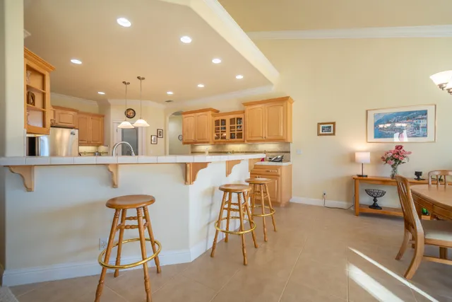 a bed sitting in a spacious bedroom next to a window