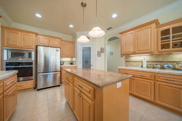 a bathroom with a granite countertop sink toilet a large mirror a shower and vanity