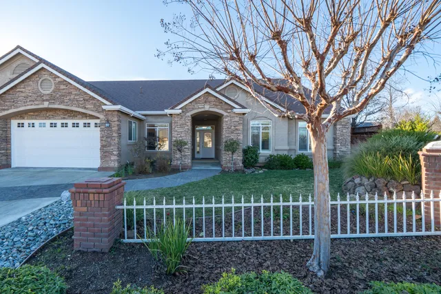 a living room with furniture a fireplace and a chandelier