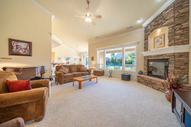 a kitchen with stainless steel appliances granite countertop a refrigerator a sink and a stove