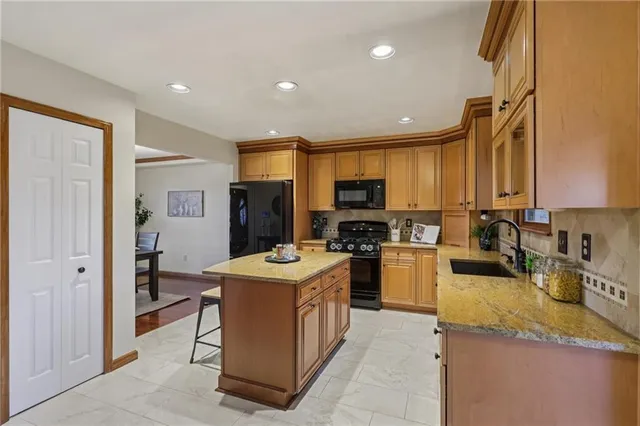an empty room with wooden floor closet and windows