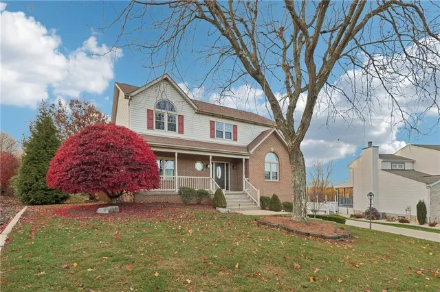 a view of a hallway with wooden floor and stairs