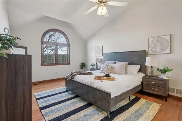 a front view of a house with a tree