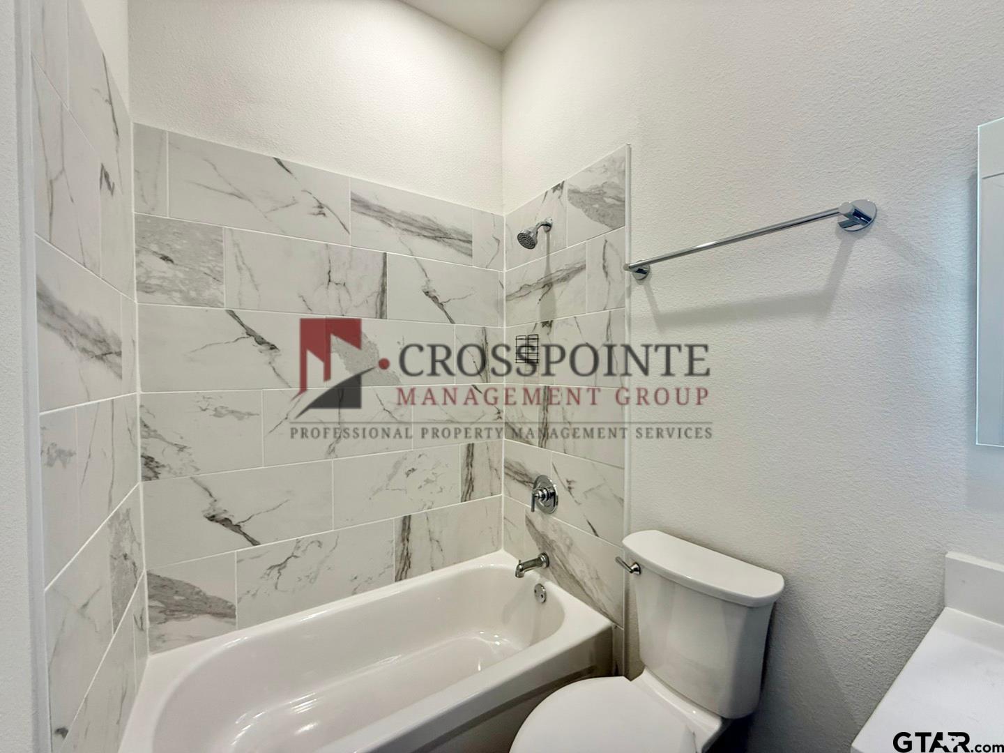 548 West Erwin Street Tyler, TX 75702 - Photo 5 of 27 a bathroom with a toilet and a shower