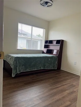 a living room with a bed furniture and a window