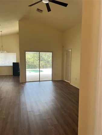 a view of a livingroom with wooden floor and a window