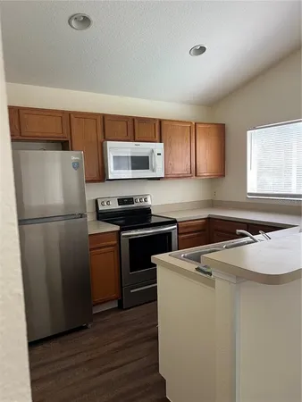 a kitchen with a refrigerator sink and stove