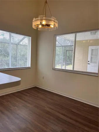 a view of a room with wooden floor and large window