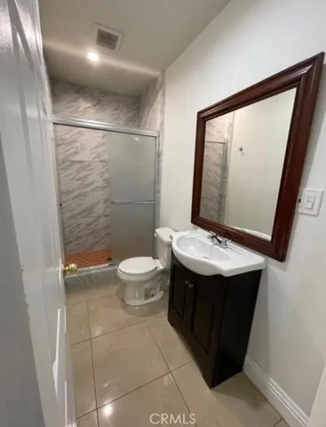 a bathroom with a sink a toilet and mirror